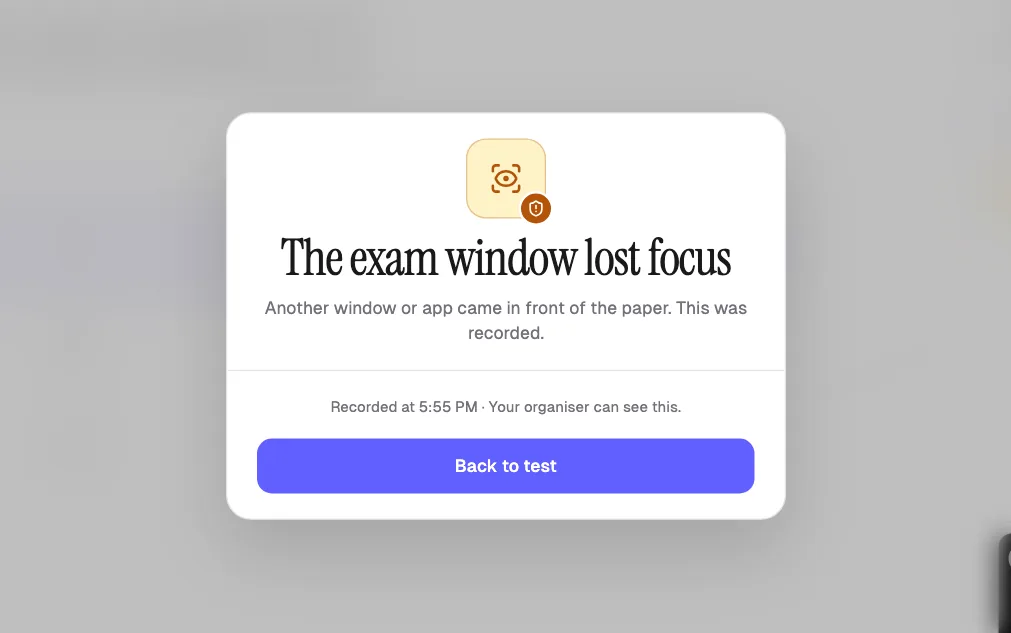 Exam paper blurred after the student switched windows, with a stay with the paper warning